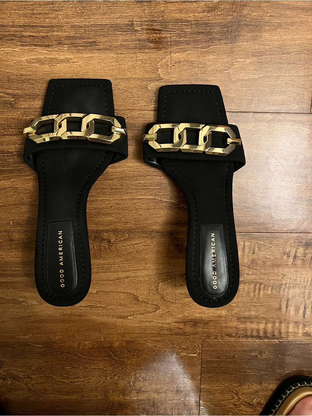 Good American Black Slide Heels with Gold Chain Accent